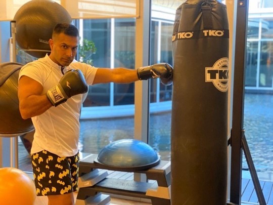 Mah in gloves working the bag